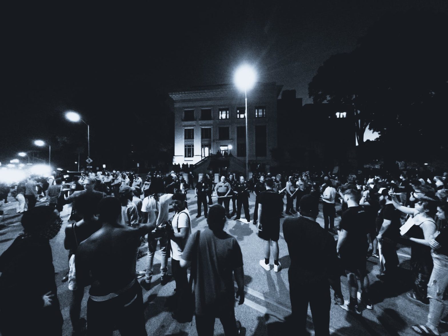 grayscale photo of protesters on a street